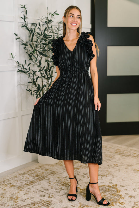 Size inclusive black pinstripe ruffle sleeve dress, front angle, comfy and cinched waistline, versatile styling.