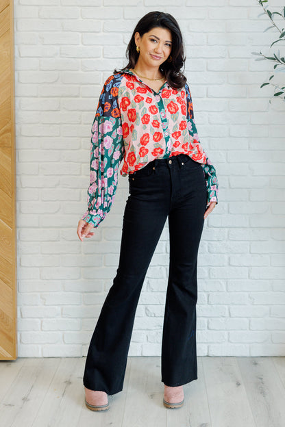Full body view of Gisselle Mixed Print Blouse paired with pants showing round hemline and balloon sleeves.