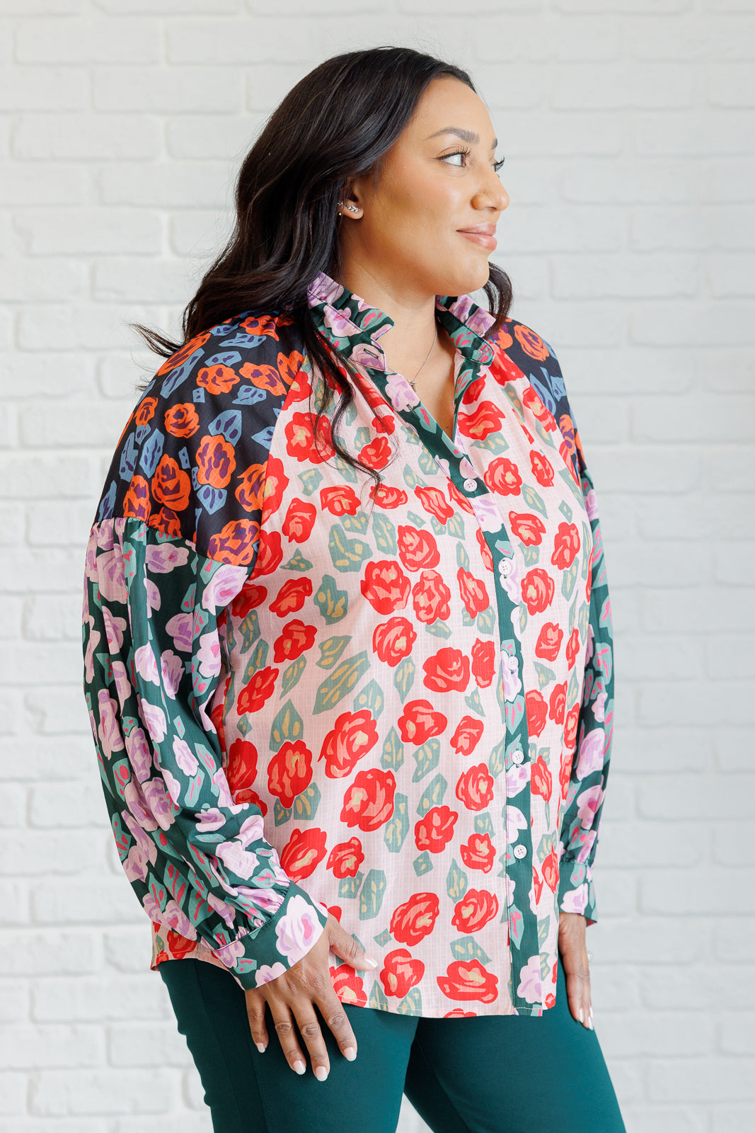 Priscilla Mixed Print Blouse with multicolor block color floral prints, high neckline, front button closures, balloon sleeves with banded cuffs, and playful ruffle detailing.