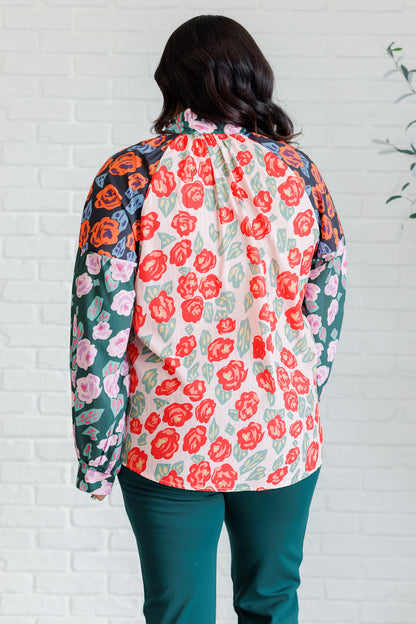 Plus size back view of Gisselle Mixed Print Blouse showing button cuff detail and floral panels