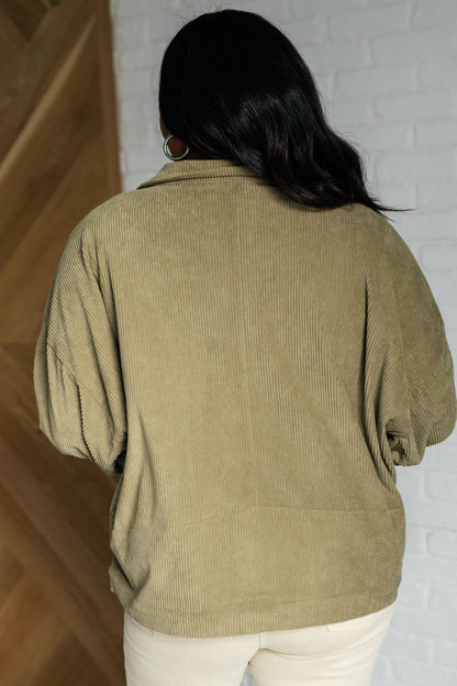 Back view of plus size model in Laylah Olive Corduroy Jacket, relaxed fit with pleated sleeve details