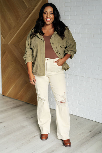 Plus size model full body view in Laylah Corduroy Jacket, olive corduroy with button cuffs and oversized fit