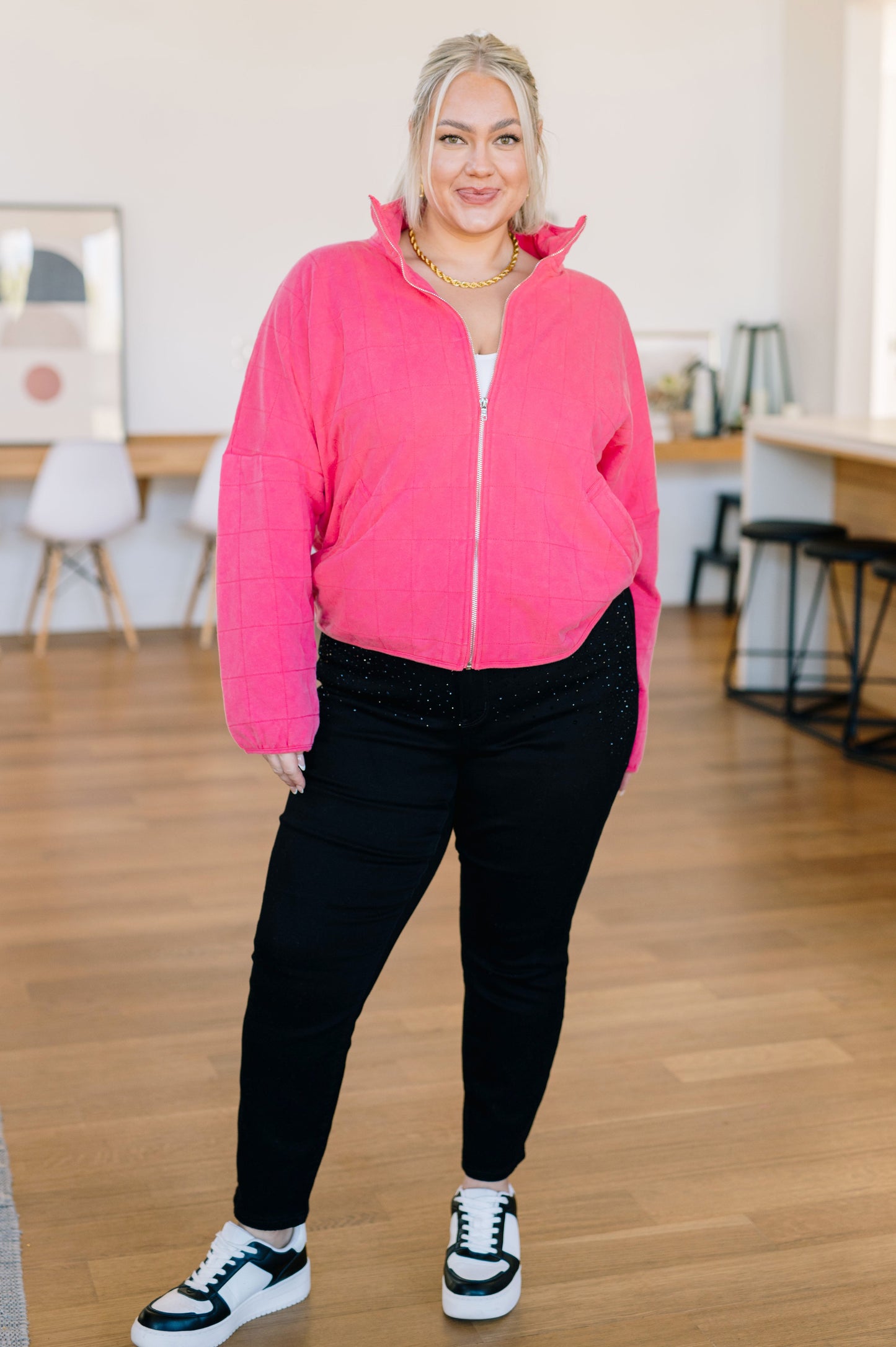 Plus size model zipping up Quinton Quilted Jacket showing comfortable mid-weight fabric.