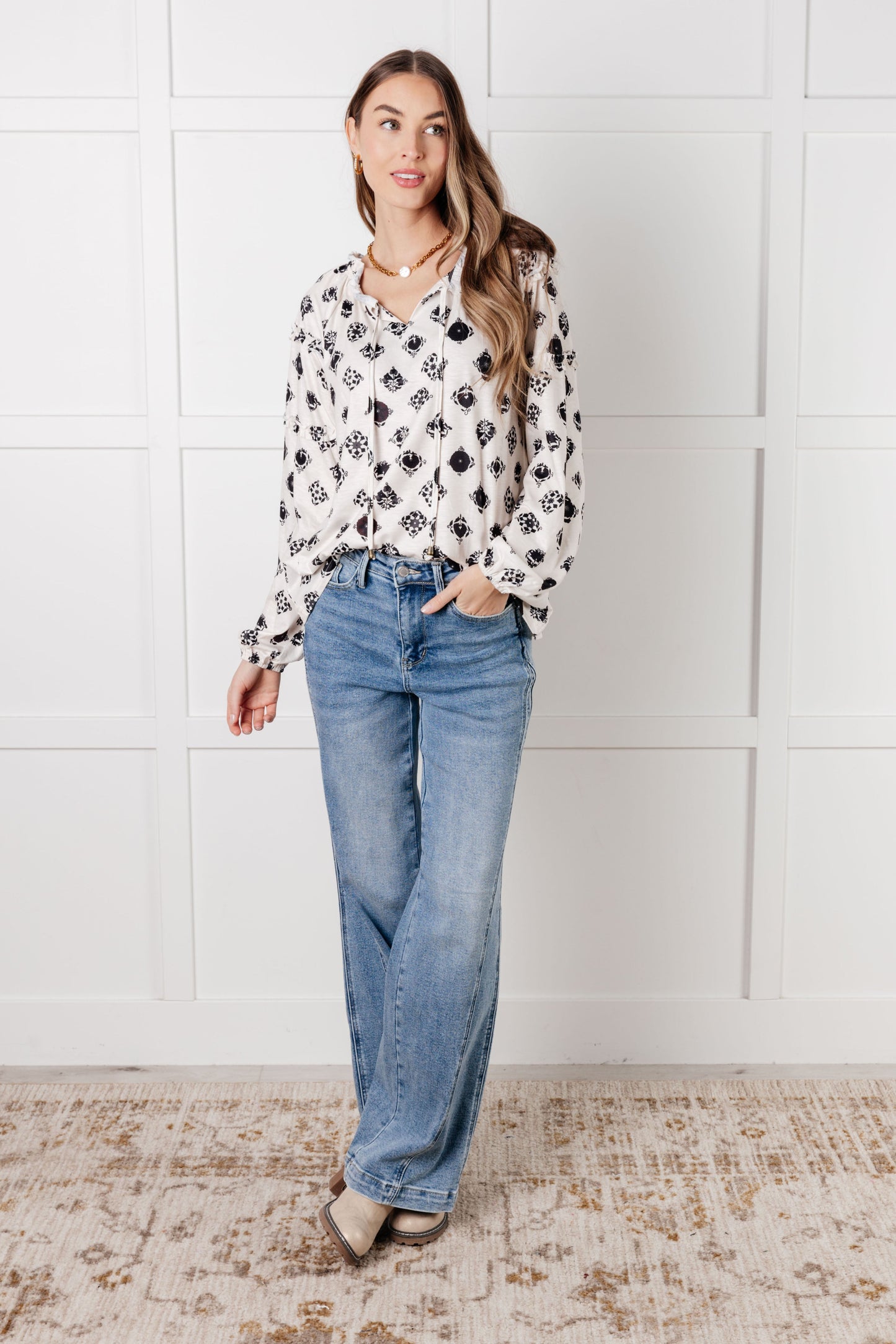 Quincy Floral Tile Blouse front angle, black floral print on white knit, perfect for fashion-forward everyday wear.