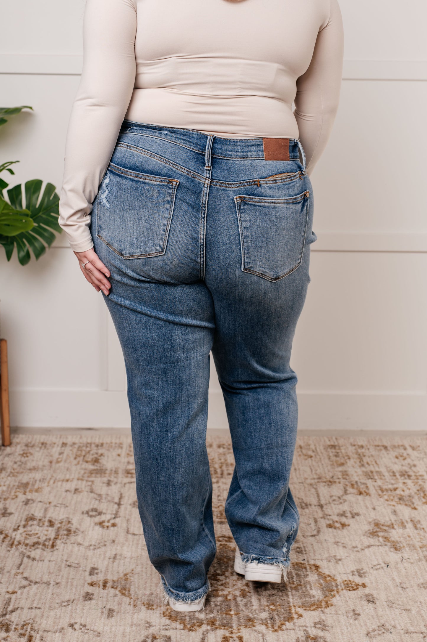 Mid Rise Cell Phone Pocket Dad Jeans in light wash by Judy Blue, featuring a hidden cell phone pocket, straight cut, and comfortable mid-rise fit.