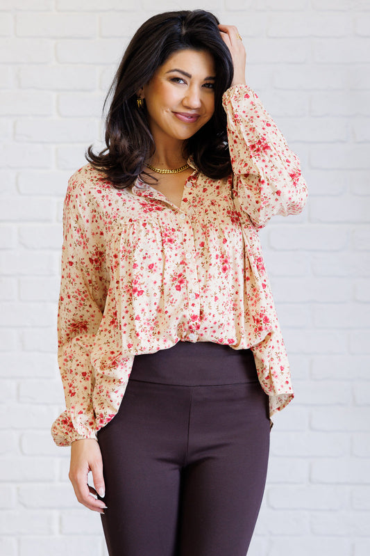 Model in front view wearing Rea Button Down floral poplin shirt with ruffle sleeves.
