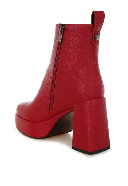 Back view of red Poulin Chelsea Boots with pull tab and sturdy block heel elevation.