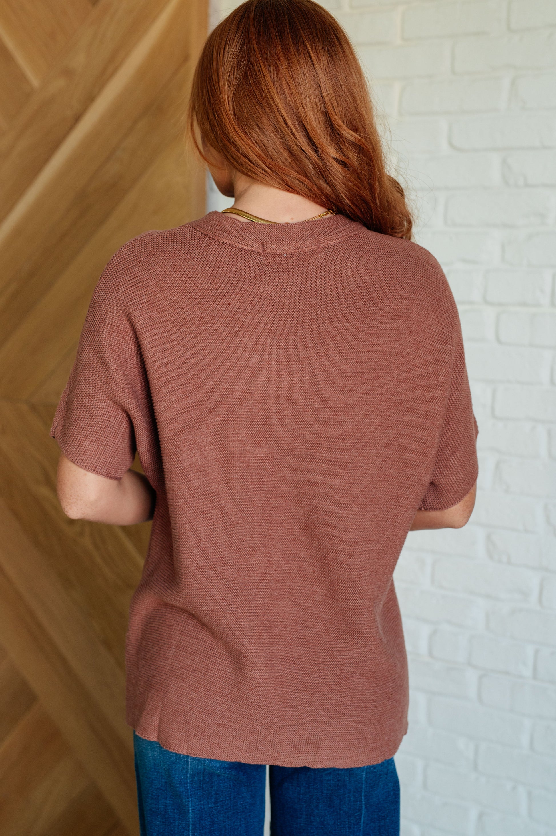 Coffee-colored sweater knit top with a round neckline, short batwing sleeves, and high stretch for comfort.