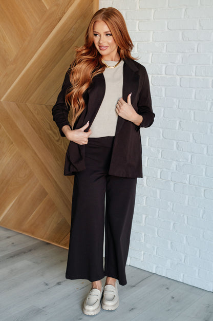 Full body view of woman styling Devi Magic Blazer in chocolate with slim fit, chic and versatile look.