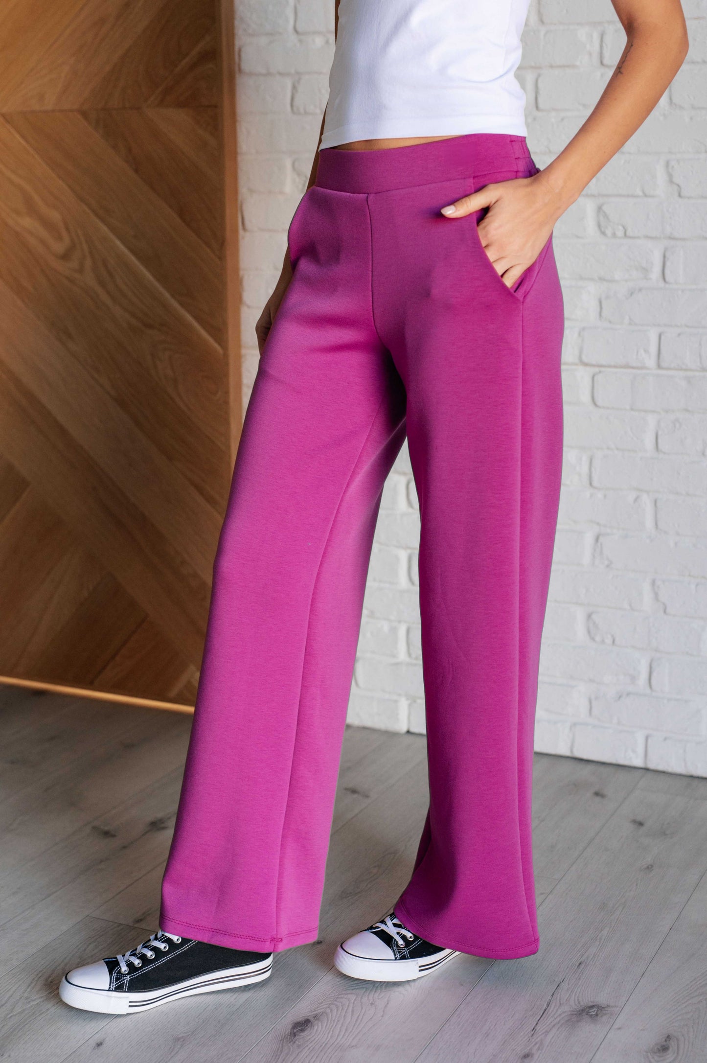 Women's magenta Hampton Wide Leg Crop Pants with a trendy wide-leg design, elastic waistline, and functional side pockets, made from scuba modal fabric.