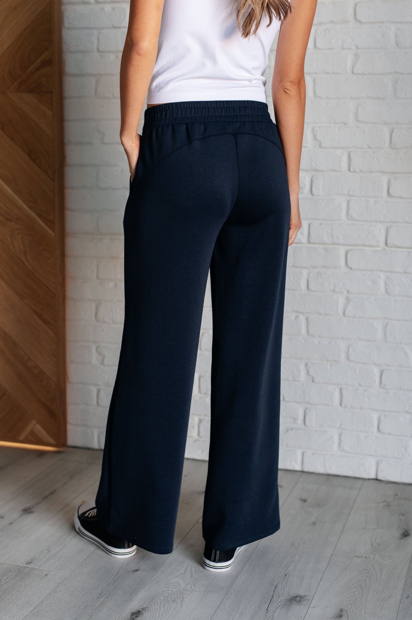 Women's navy  wide leg crop pants with a trendy wide-leg design, elastic waistline, and functional side pockets, made from scuba modal fabric.