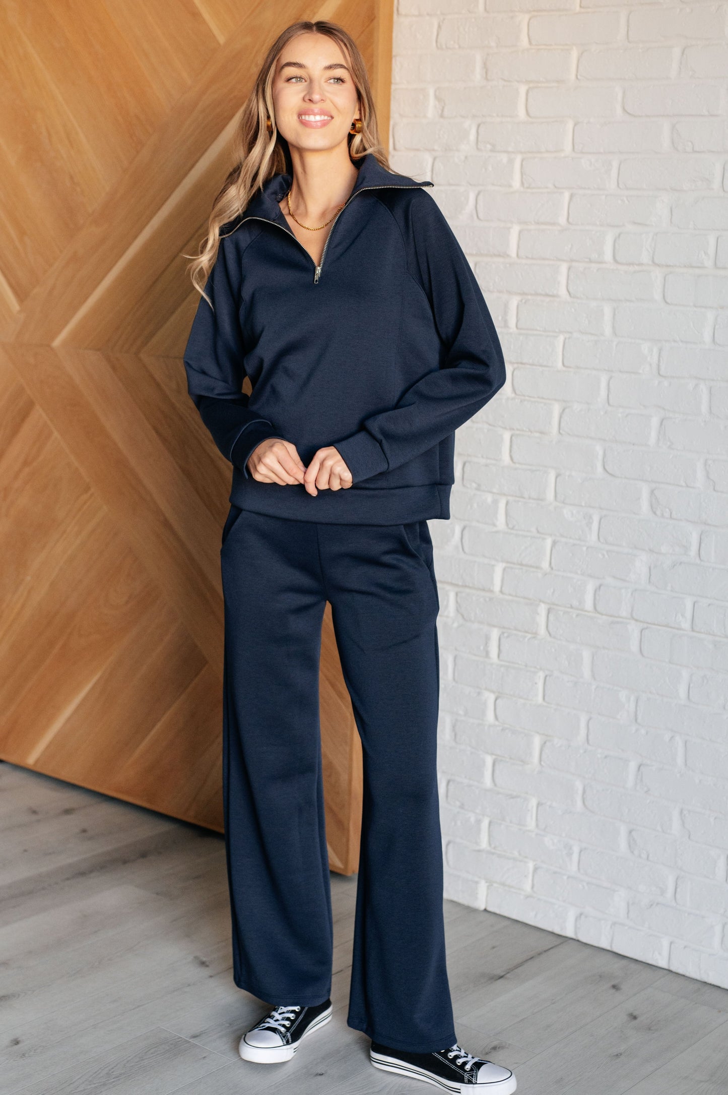 Women's navy  wide leg crop pants with a trendy wide-leg design, elastic waistline, and functional side pockets, made from scuba modal fabric.