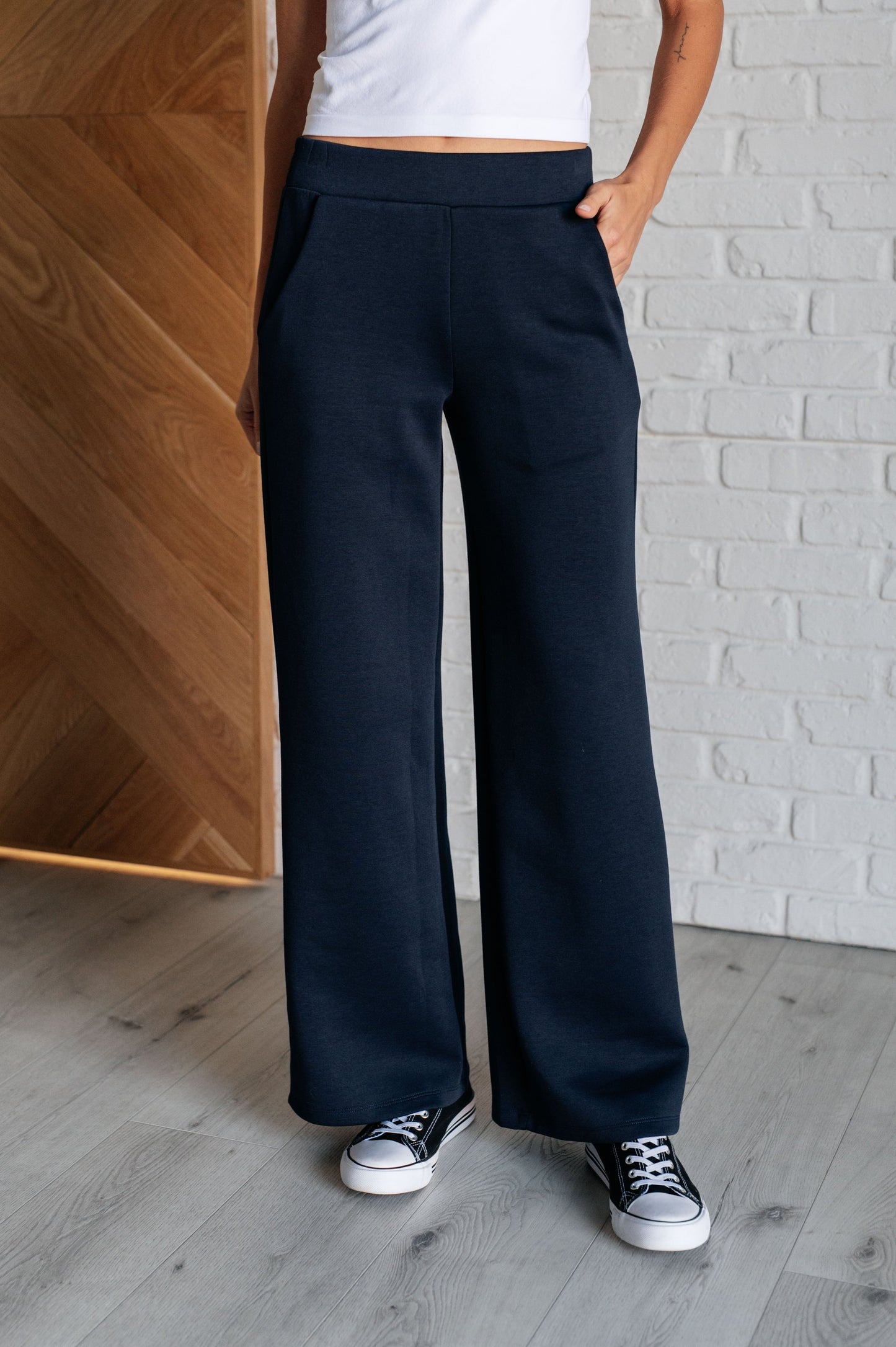 Women's navy  wide leg crop pants with a trendy wide-leg design, elastic waistline, and functional side pockets, made from scuba modal fabric.