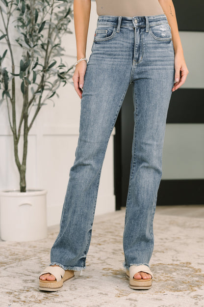 Robin High Waist Bootcut Jeans light wash front view with frayed hem and light distressing.