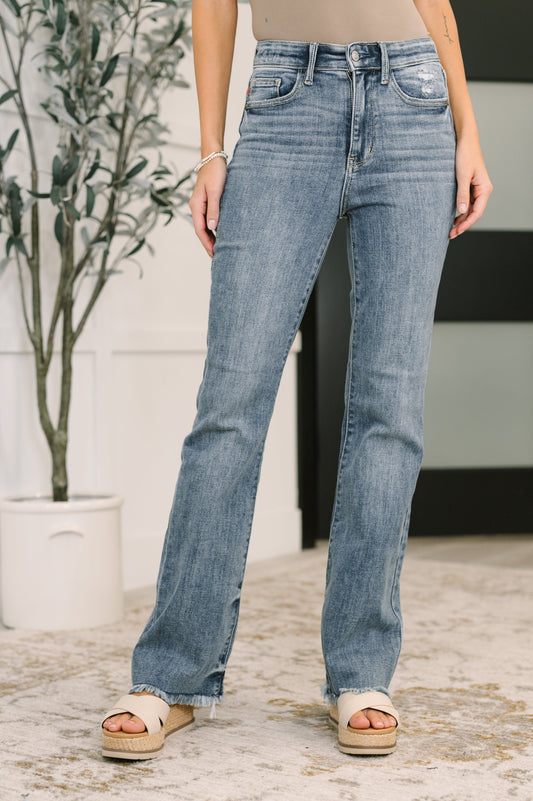 Robin High Waist Bootcut Jeans light wash front view with frayed hem and light distressing.