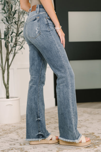 Robin High Waist Bootcut Jeans side angle showing bootcut fit and frayed hem.