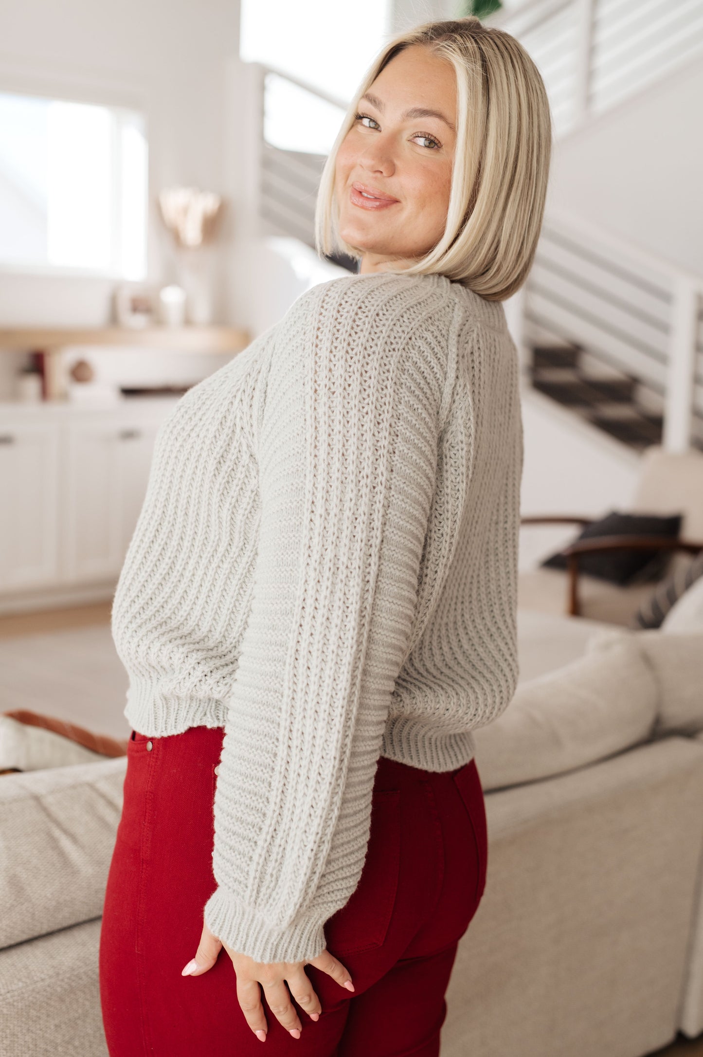 Plus size model in cream Hattie Balloon Sleeve Sweater showing textured knit sleeves.