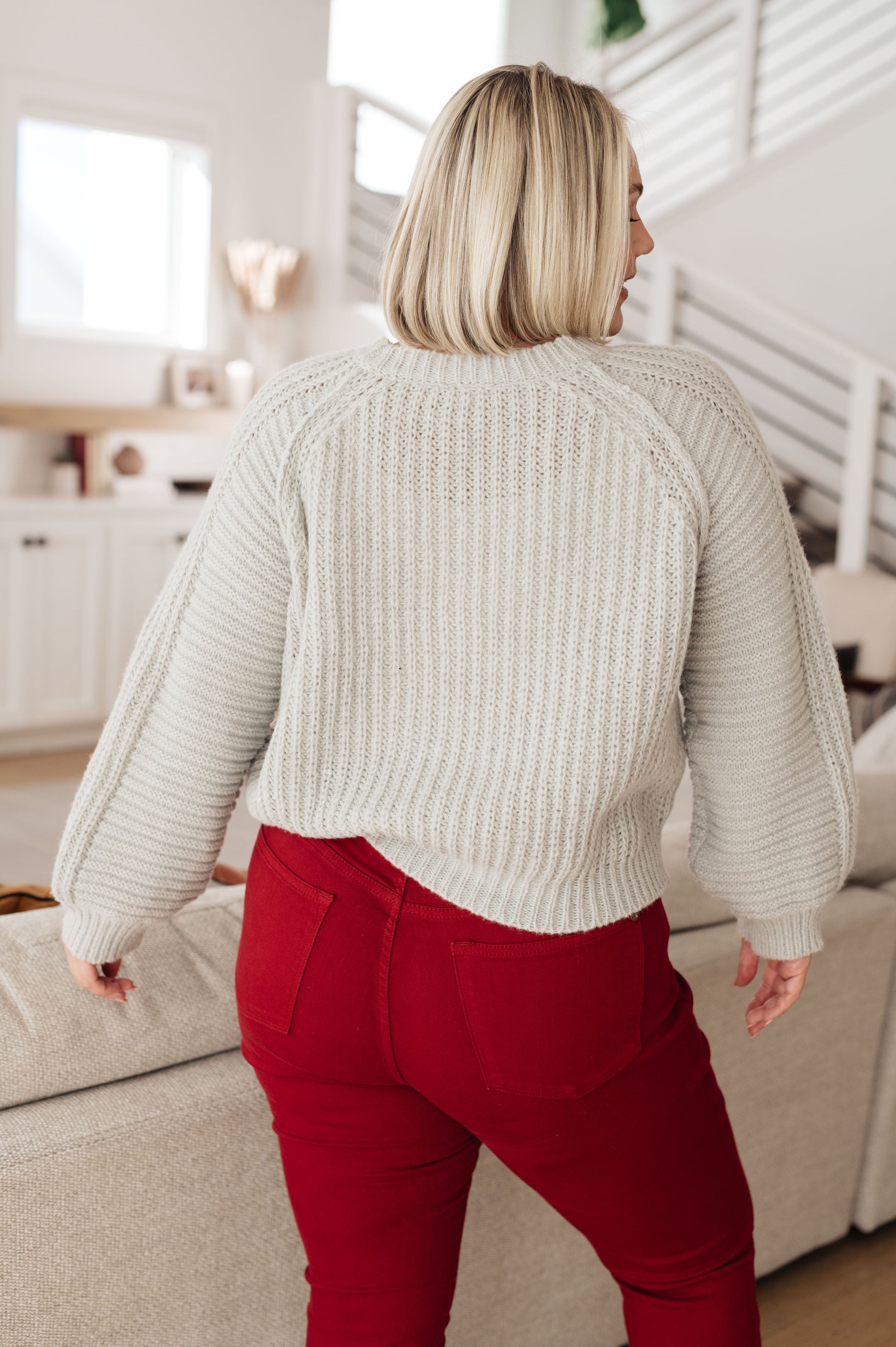 Plus size model in Hattie Balloon Sleeve Sweater from behind showing cozy oversized fit.