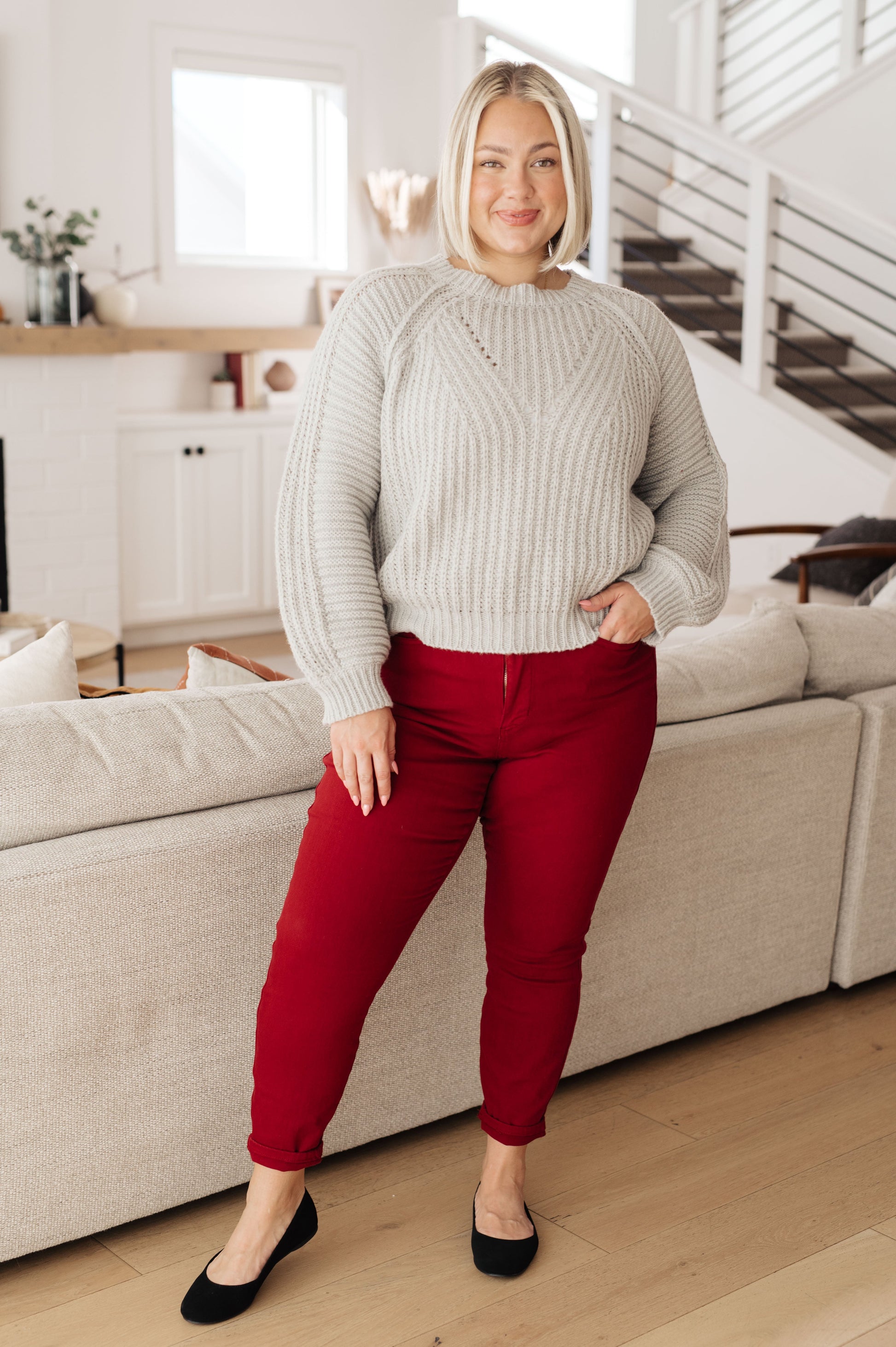 Plus size model in Hattie Balloon Sleeve Sweater with red pants and flats.