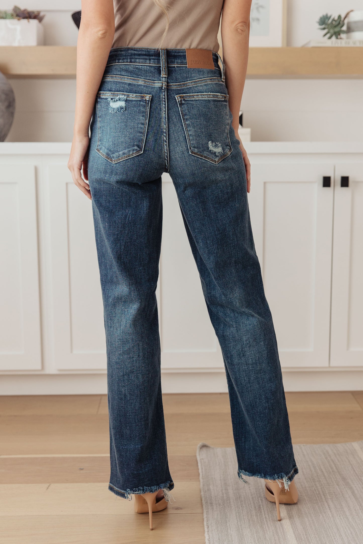 Judy Blue Rose High Rise 90's Straight Jeans in dark wash, featuring a zip fly, distressing, chewed hems, and 4-way stretch for a flattering fit.