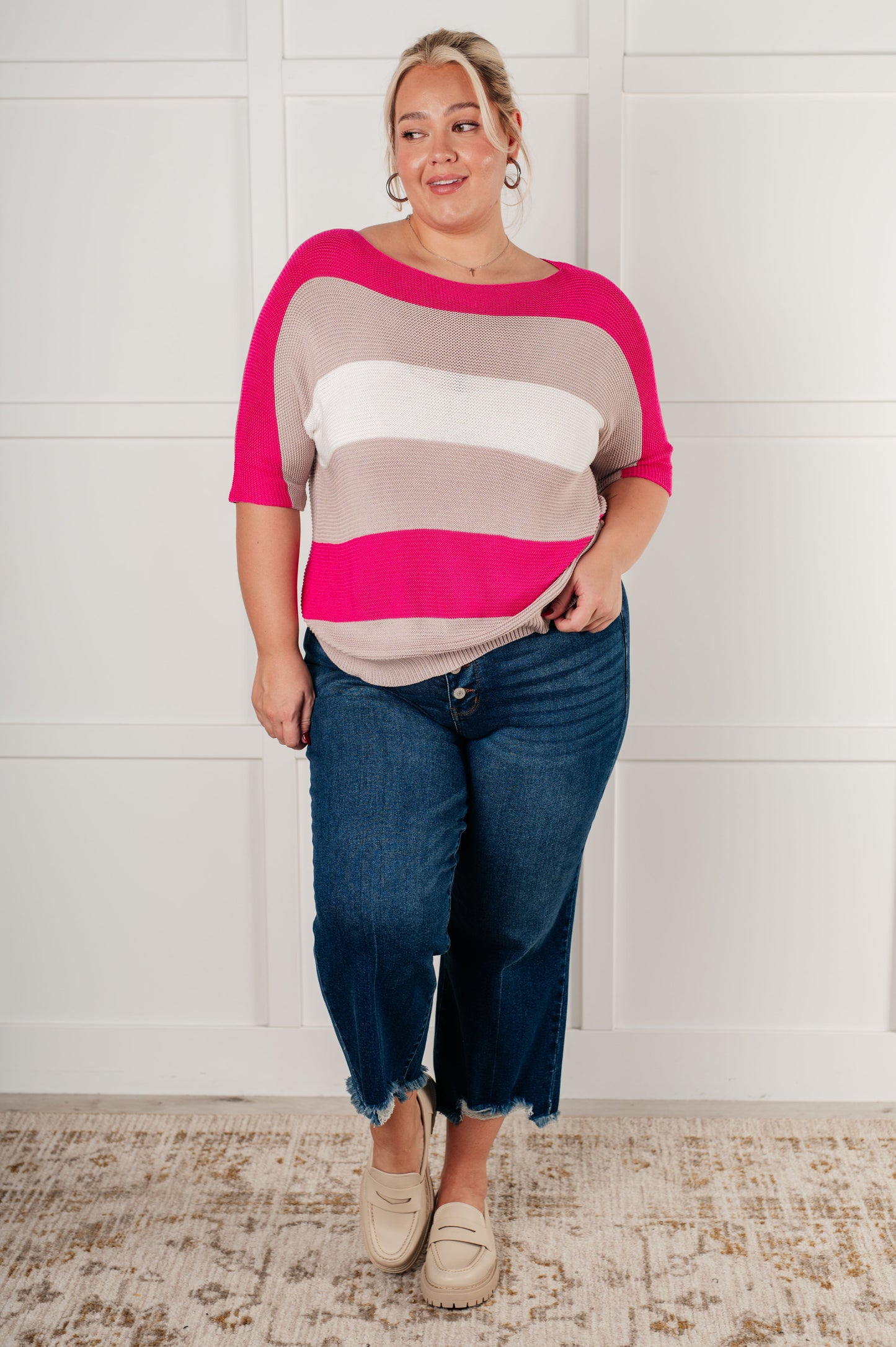 Women's Short Sleeve Knit Top in pink with a striped pattern, featuring a boat neckline, short dolman sleeves, and an exaggerated ribbed hemline. Made from mid-weight sweater knit fabric.