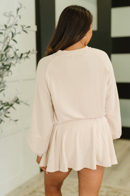 Back view of model wearing Winnie Top and Skort Set in cream ribbed knit