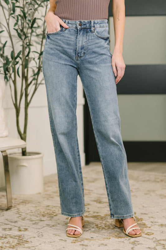 Model wearing Sabrina High Waist Slim Straight Jeans by Judy Blue with tummy control and distressed hem.