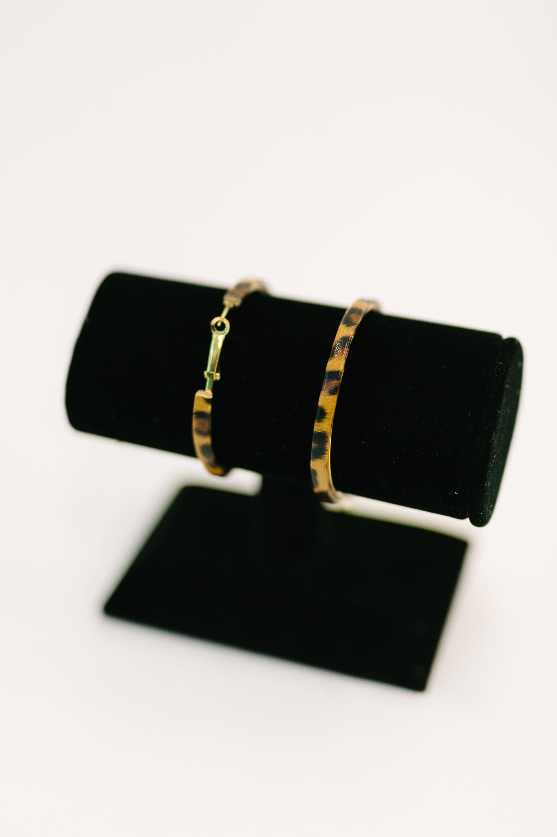 Flat lay of Sassy Assist Leopard Print Hoop Earrings statement hoop jewelry.