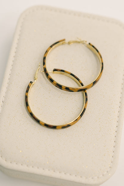 Front view of Sassy Assist Leopard Print Hoop Earrings showing leopard pattern detail.