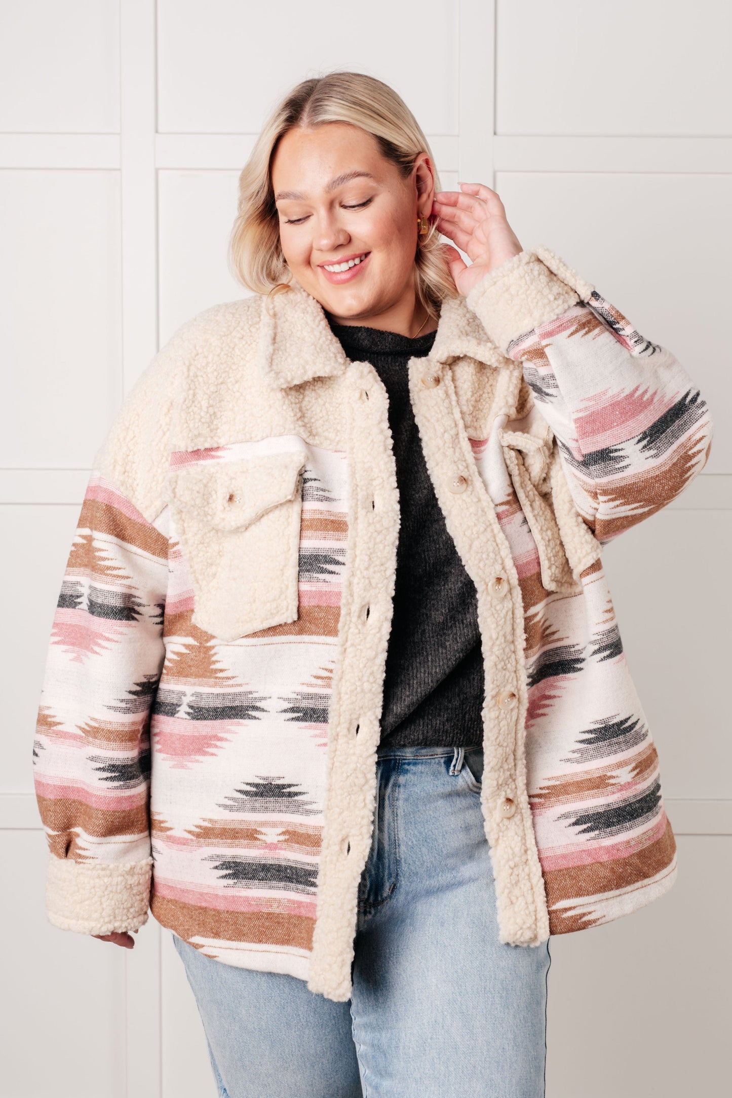 Plus size model wearing Sedona Sunset Shacket in beige Aztec print with sherpa fleece.