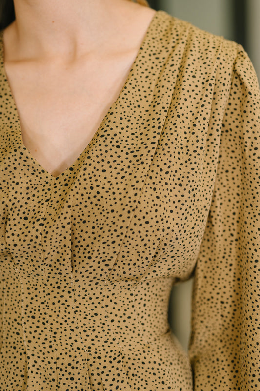 Close-up of Selah V-Neck Dress showing spotted print detail.