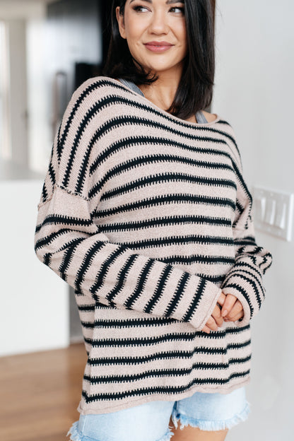 Side angle of Selma Striped Sweater highlighting exposed seams and stripe pattern.