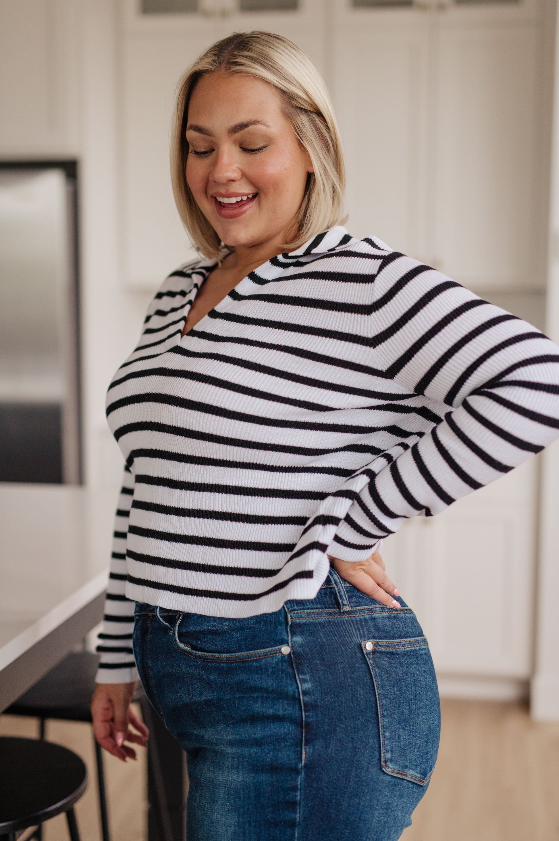 Women's lightweight ribbed striped sweater with a collared V-neckline, long sleeves, and a comfort fit. Made from 100% cotton.