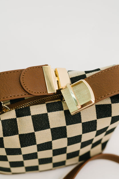 Detail shot of Send a Check Crossbody Bag gold hardware and buckle clip.