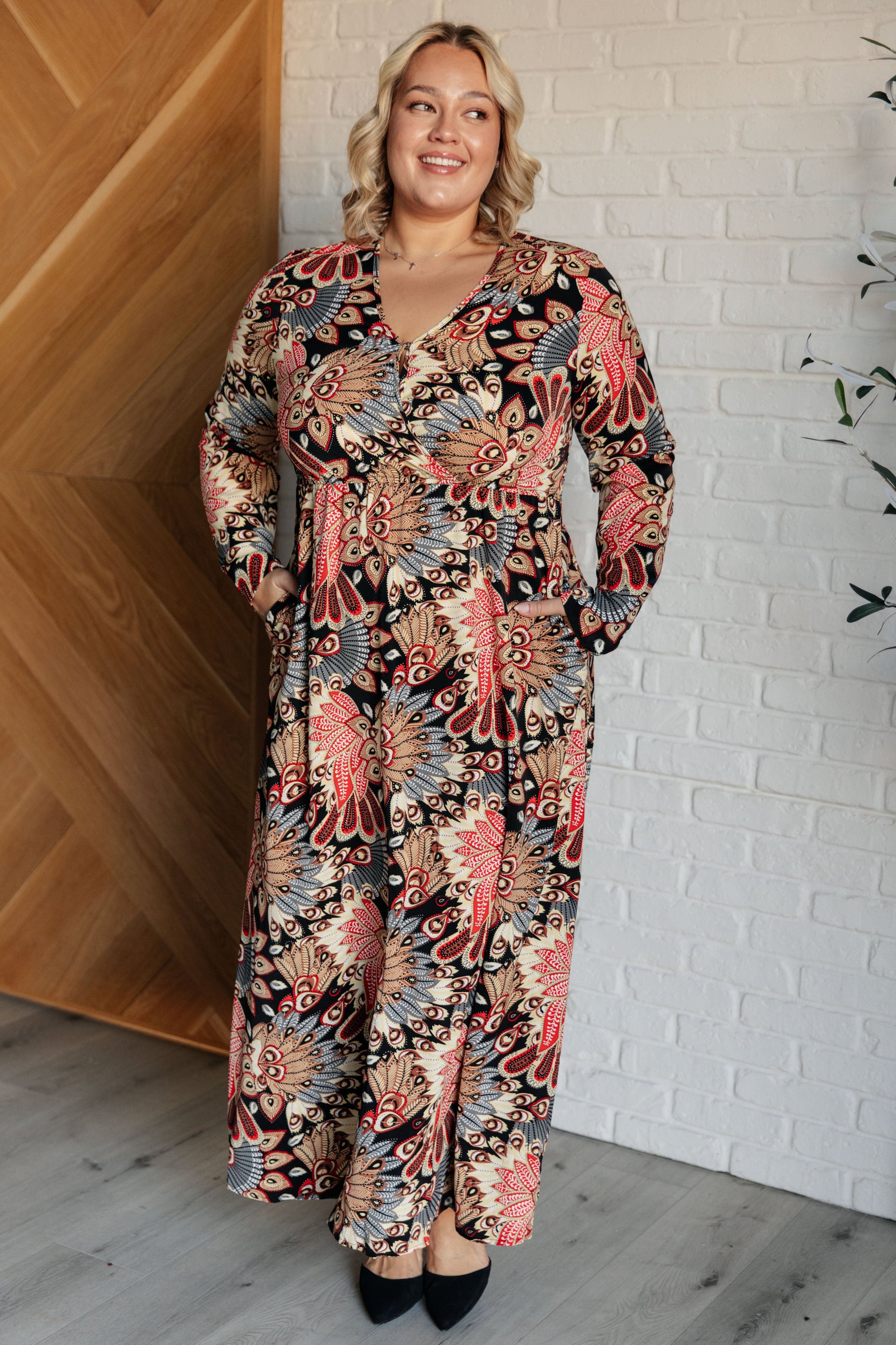 Women's floral multicolor Orla Faux Wrap Maxi Dress with a V-neckline, long sleeves, high elastic waistline, A-line silhouette, snap button closure, and functional side pockets, made from poplin woven fabric. 