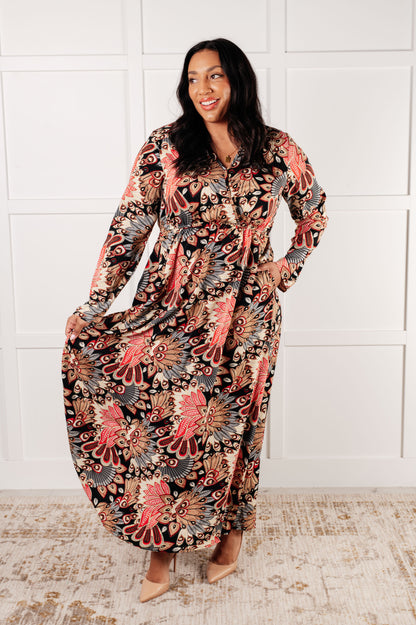 Plus size model wearing Senna Faux Wrap Maxi Dress in black floral print with V-neckline.