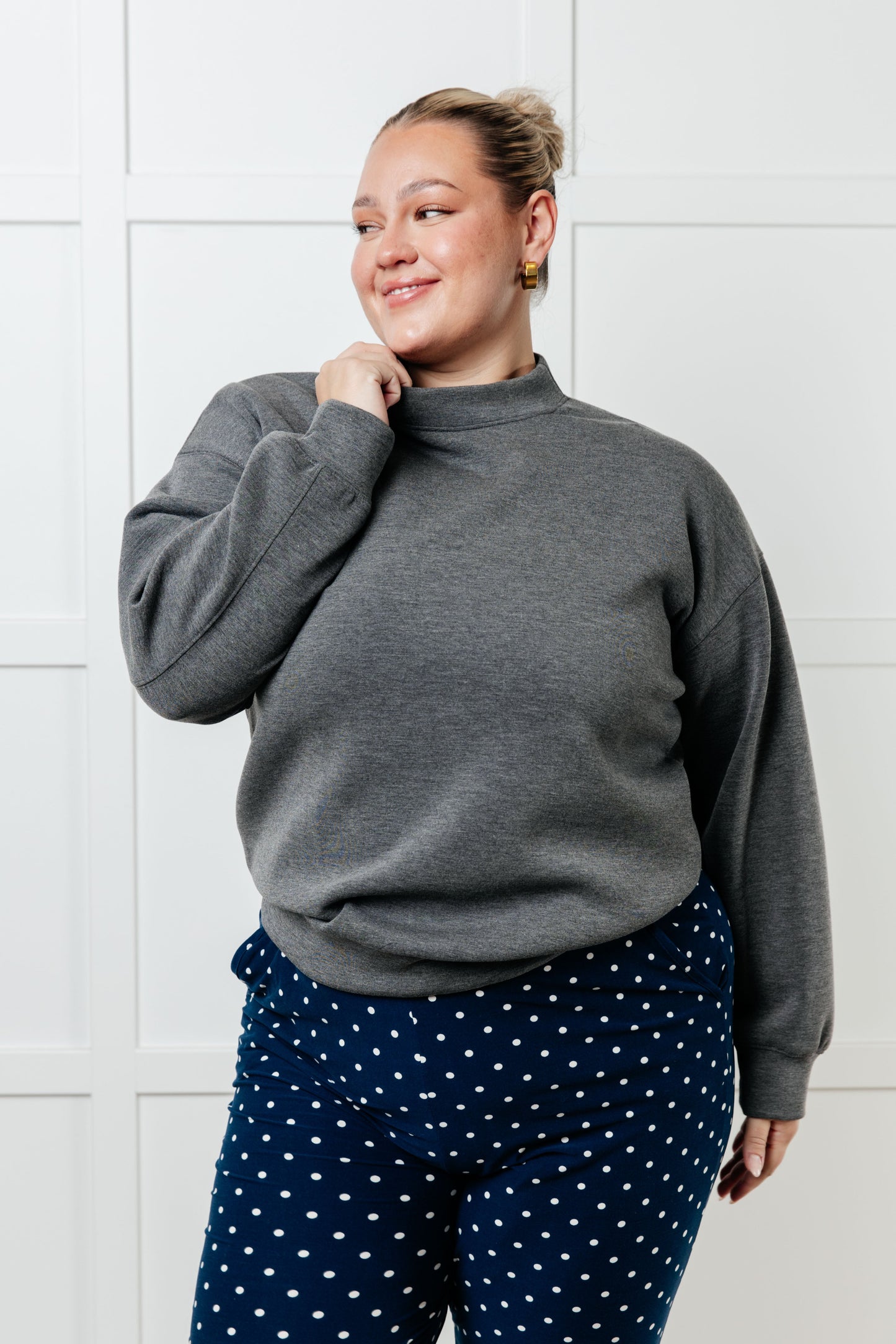 A women's gray sweatshirt made from micro scuba knit fabric, featuring a mock neckline, long sleeves, and a relaxed fit.