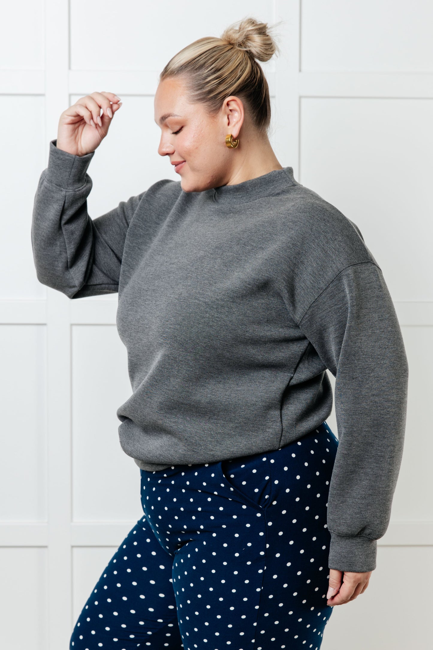 A women's gray sweatshirt made from micro scuba knit fabric, featuring a mock neckline, long sleeves, and a relaxed fit.