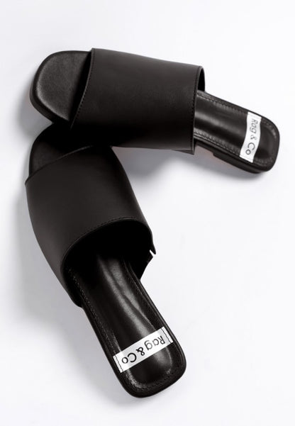 Close up of Shanon Slip-On Leather Flats in Black leather texture and stitching.