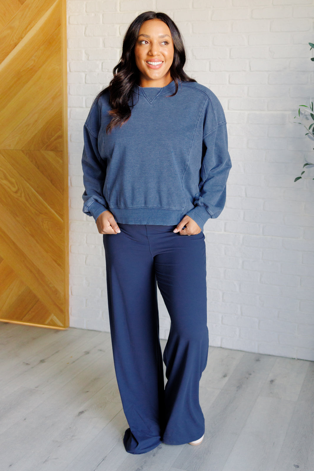 Navy brushed microfiber onesie with a scoop neckline, slim fit top, relaxed straight bottom, and a built-in shelf bra with removable cups for support.