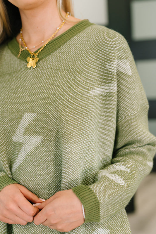 Close-up of Shoni V-Neck Sweater in Olive showing ribbed V-neck and soft knit texture.