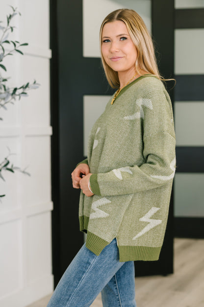 Side angle of Shoni V-Neck Sweater in Olive highlighting relaxed fit and mid-weight knit.