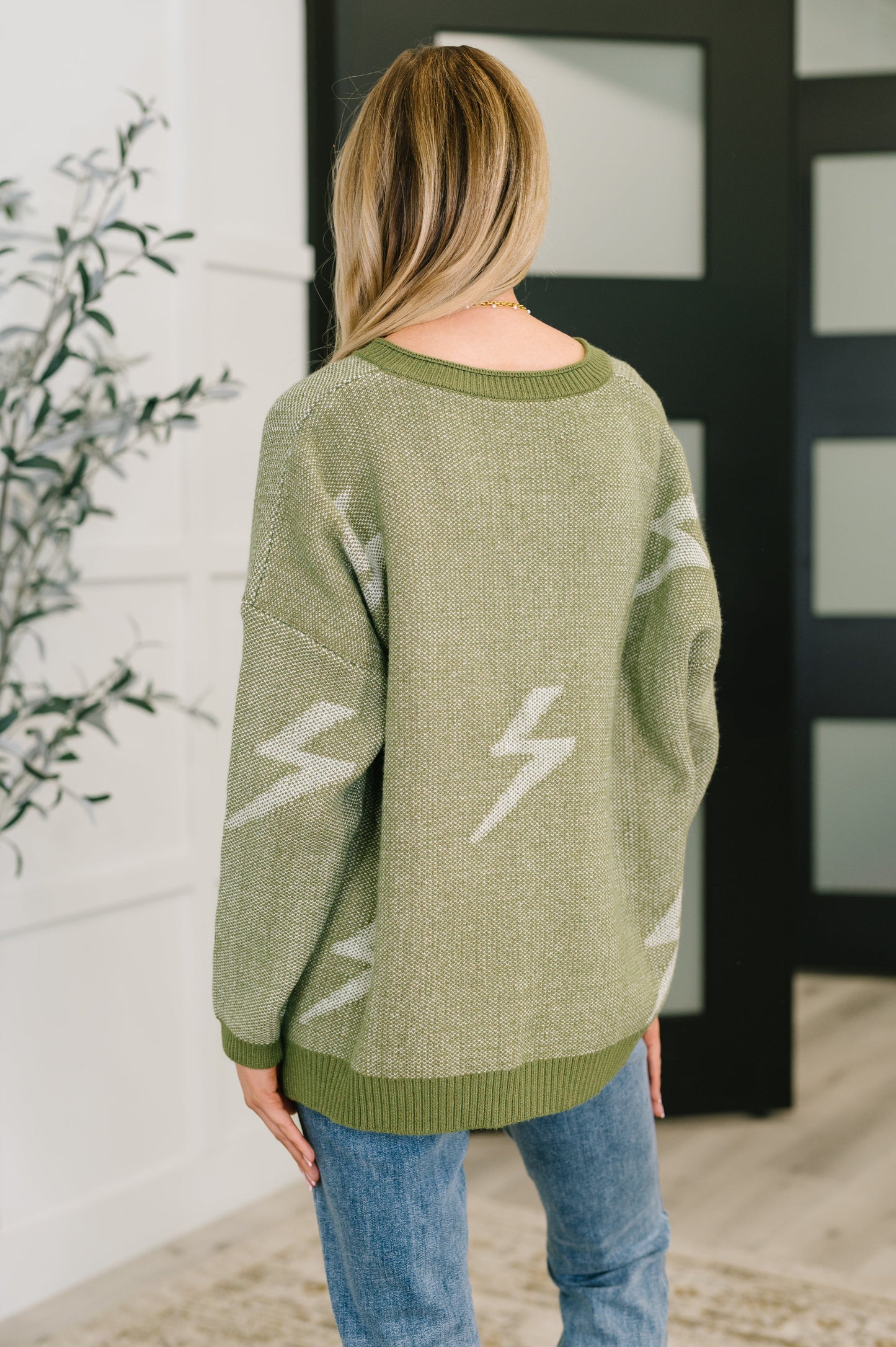 Back view of Shoni V-Neck Sweater in Olive featuring subtle lightning bolt design.