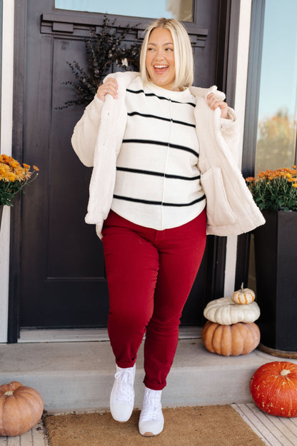 Plus size model styling Shreya Sherpa Coat open over jeans and knit top for winter chic.