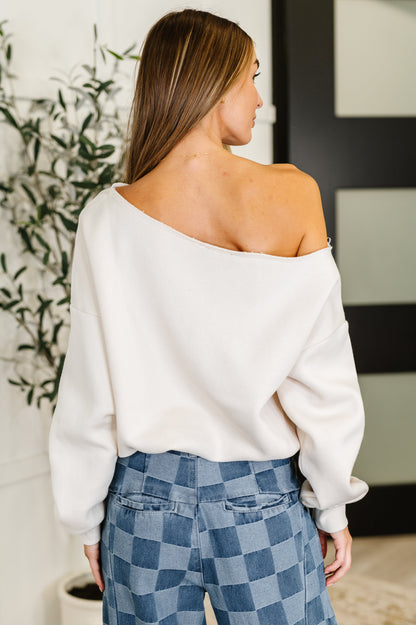 Back view of Marlowe Off Shoulder Top in Bone showcasing the banded hem and soft French terry fabric for a cozy finish.