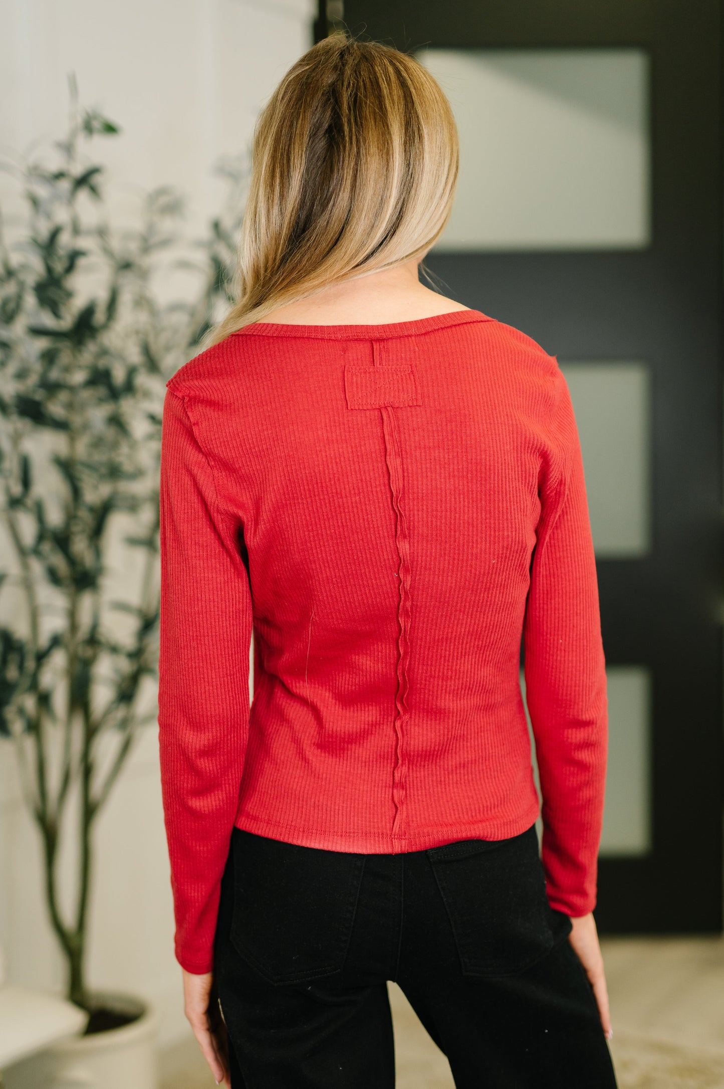 Back view of Sigourney Button Down Cardigan showing exposed seam details.