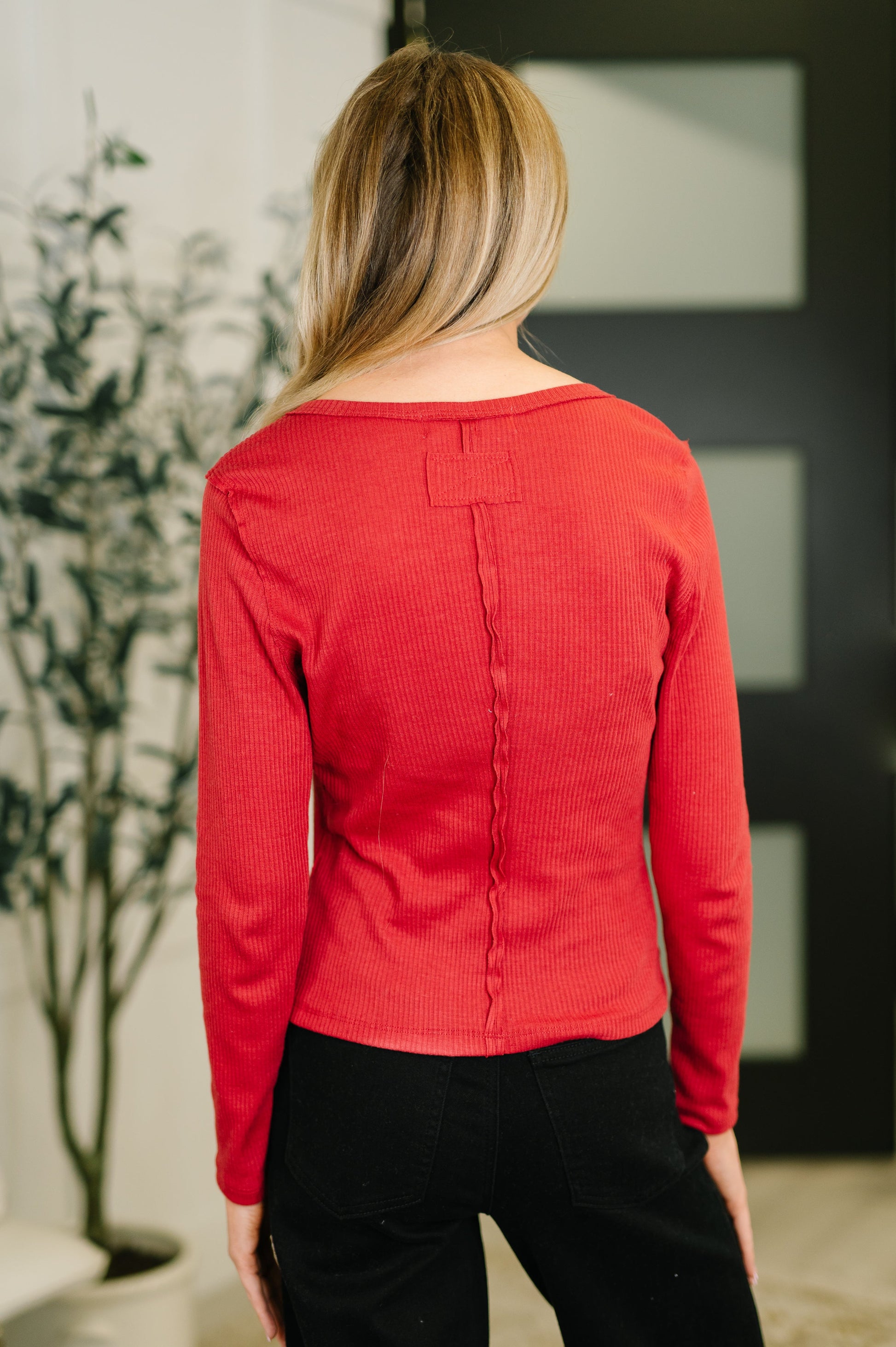 Back view of Sigourney Button Down Cardigan showing exposed seam details.