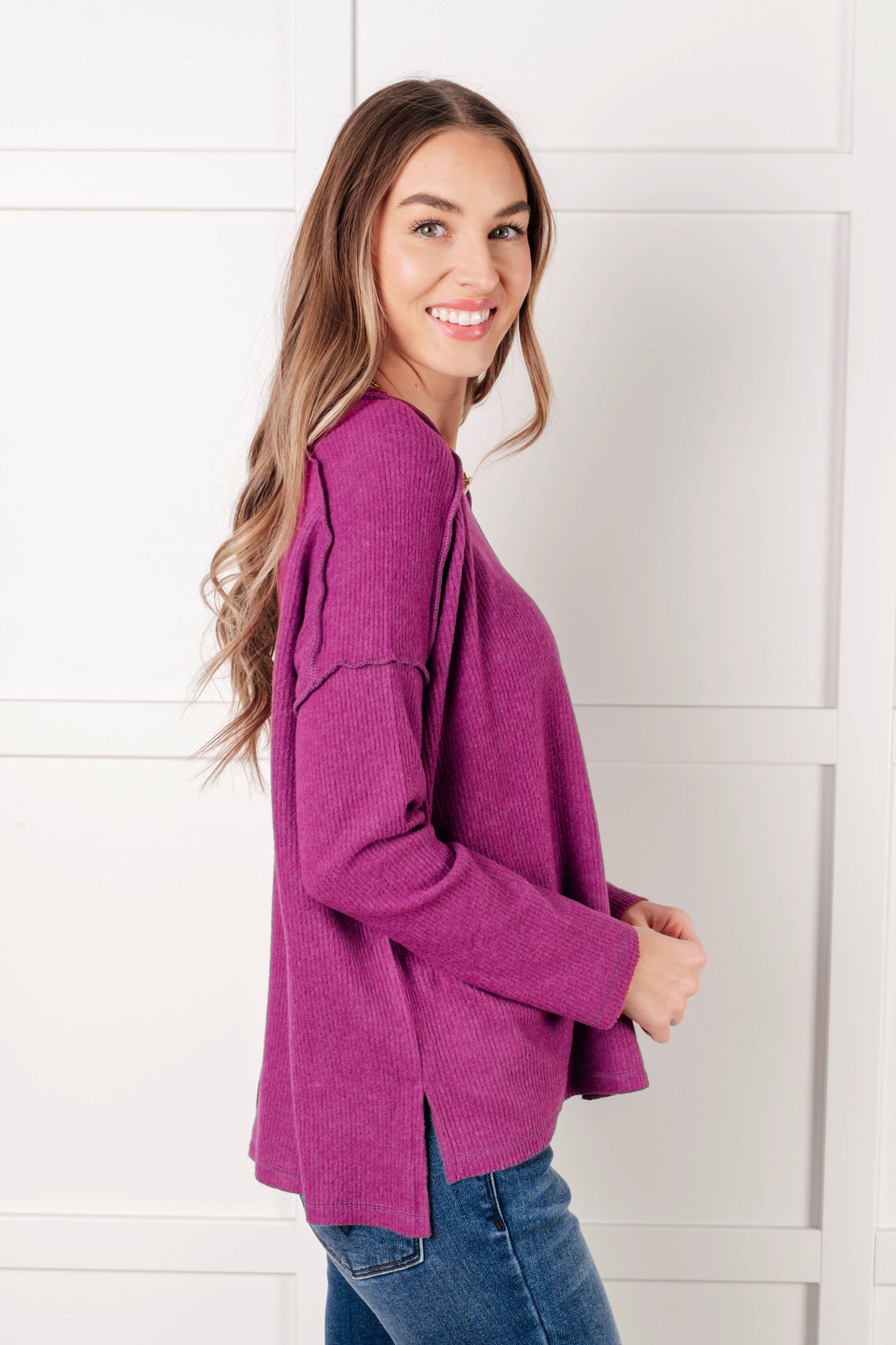 Side view of plum Simon Ribbed Hacci Sweater with ribbed texture and exposed seam details.