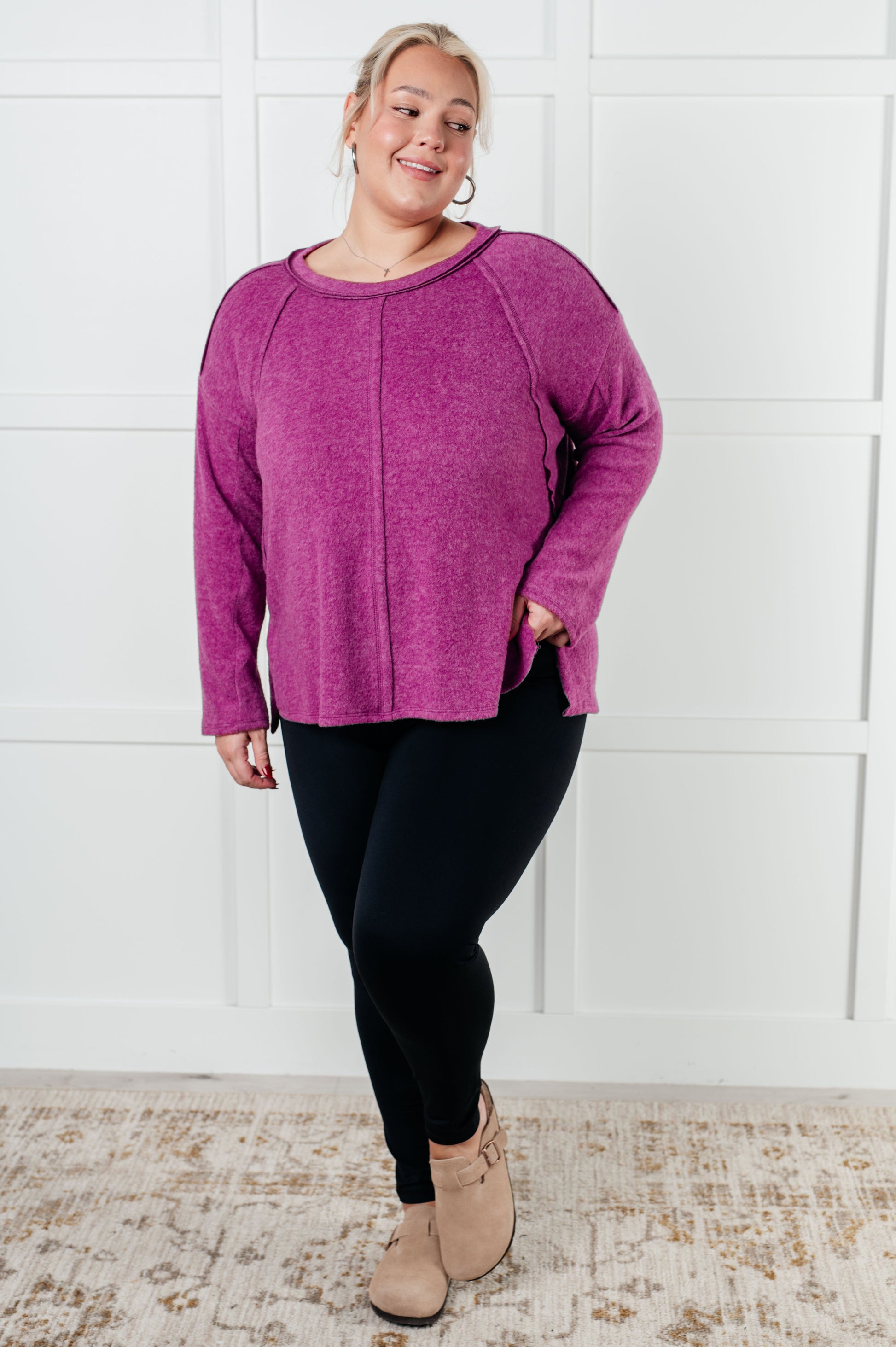 Women's Brushed Hacci Sweater in light plum featuring a round neckline, drop shoulders, stepped hemline, side slits, and raw seams. 