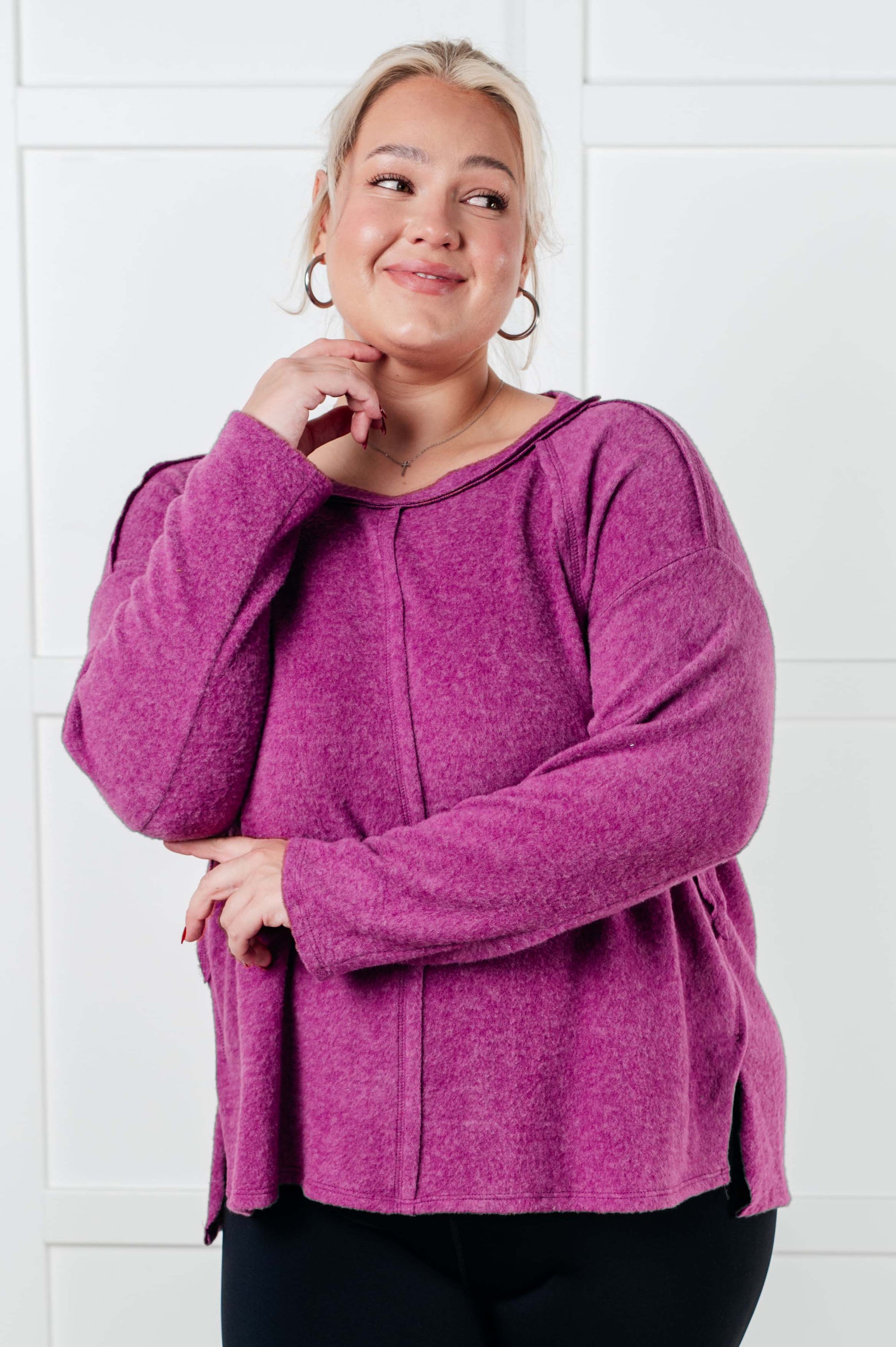 Women's Brushed Hacci Sweater in light plum featuring a round neckline, drop shoulders, stepped hemline, side slits, and raw seams. 